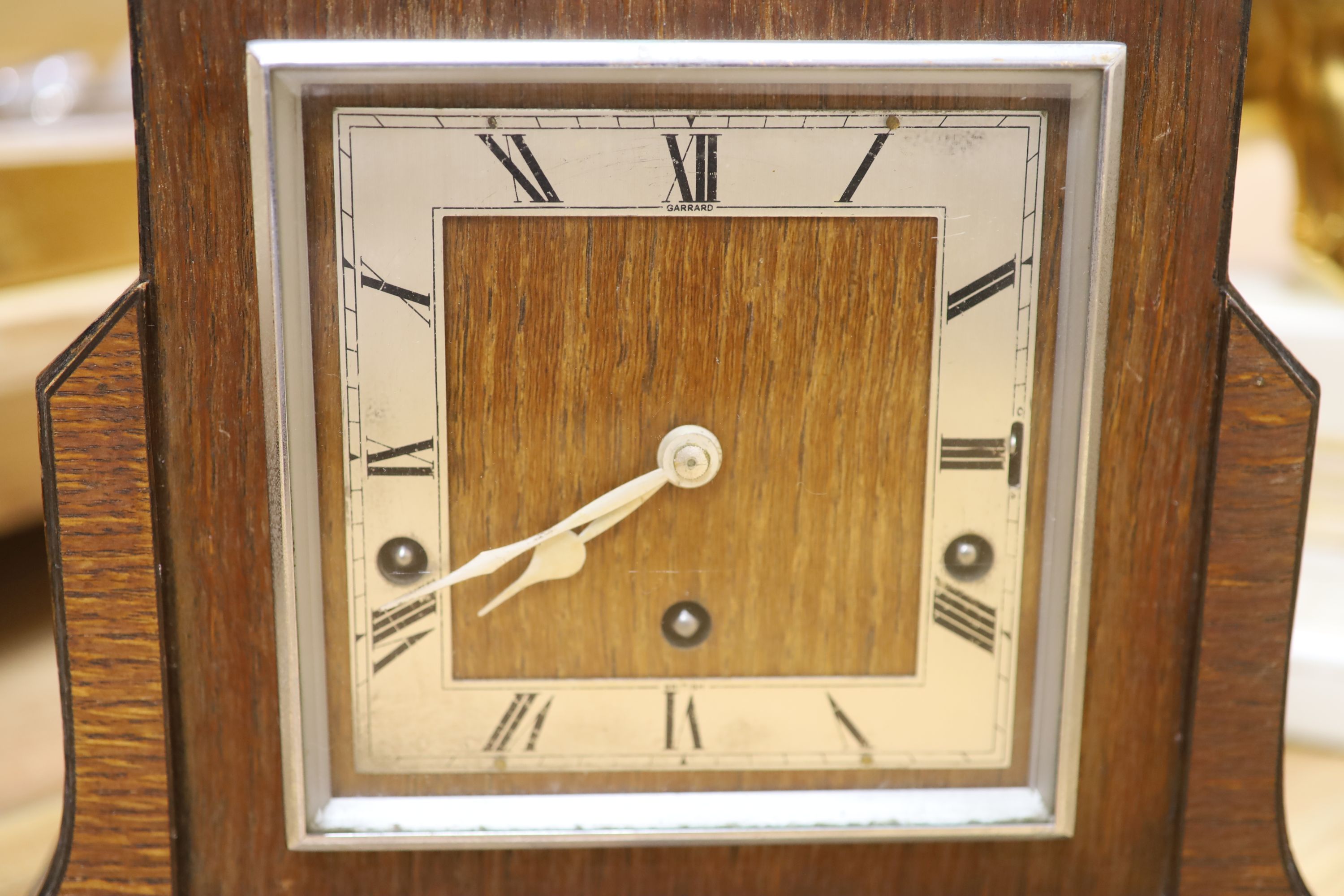 Two wooden Art Deco clocks and a ceramic clock modelled with lion cub